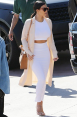 Kim K rocks a white co-ord and pink duster jacket